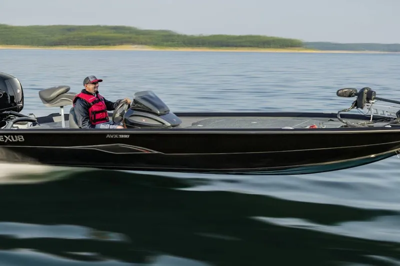 The Image of 2027 Vexus AVX1980 boat cruising on a lake with a person steering. - 1
