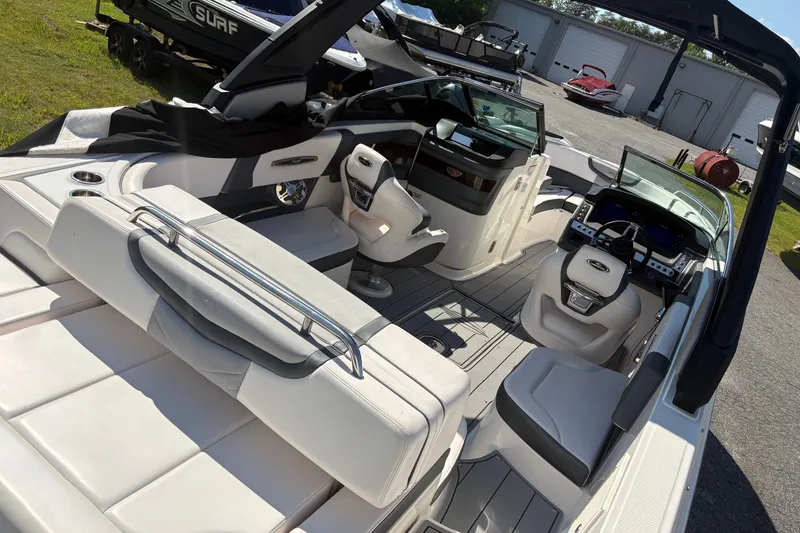 Slide: The Image of 2021 Chaparral 267 SSX boat interior with luxurious seating and modern dashboard. - 4