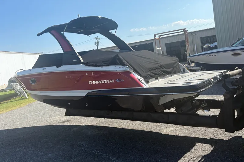 Slide: The Image of 2021 Chaparral 267 SSX boat on trailer, covered and parked outdoors. - 1