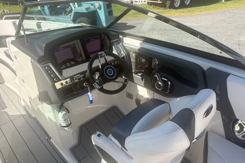 Slide: The Image of 2021 Chaparral 267 SSX boat cockpit with modern steering and dual displays. - 9