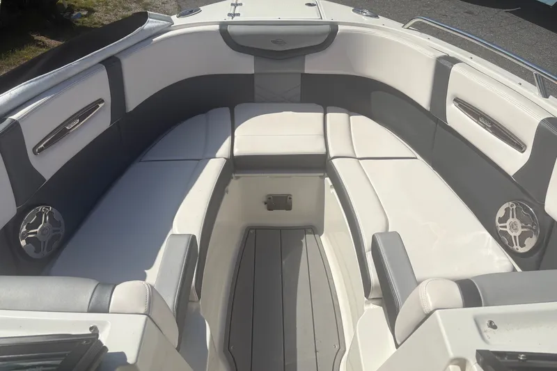 Slide: The Image of 2021 Chaparral 267 SSX boat interior with white and gray seating. - 11