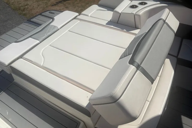 Slide: The Image of 2021 Chaparral 267 SSX boat with luxurious white and gray seating. - 6