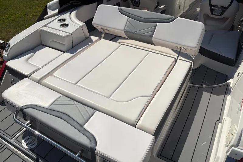 Slide: The Image of 2021 Chaparral 267 SSX boat interior with luxurious white seating and cup holders. - 7