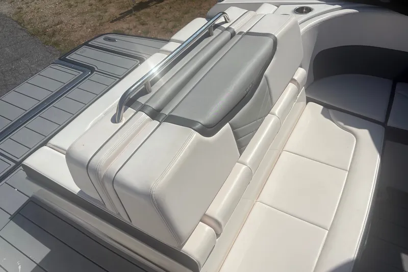 Slide: The Image of 2021 Chaparral 267 SSX boat with luxurious white seating and sleek design. - 5