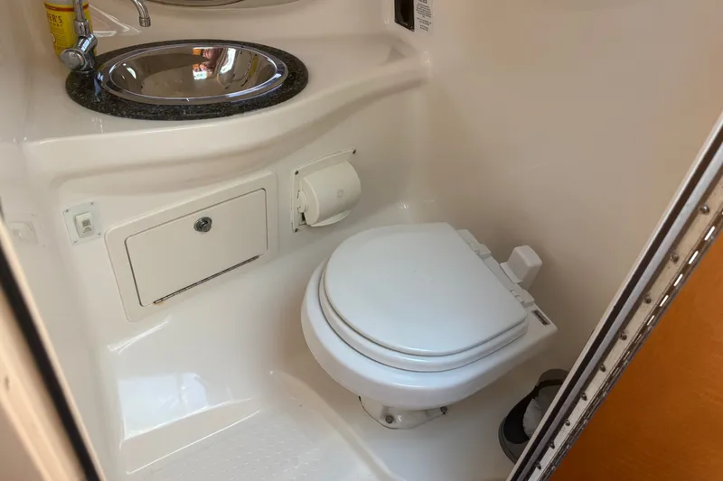 Slide: The Image of Compact bathroom in 2007 Chaparral 275 SSi boat with sink and toilet. - 15