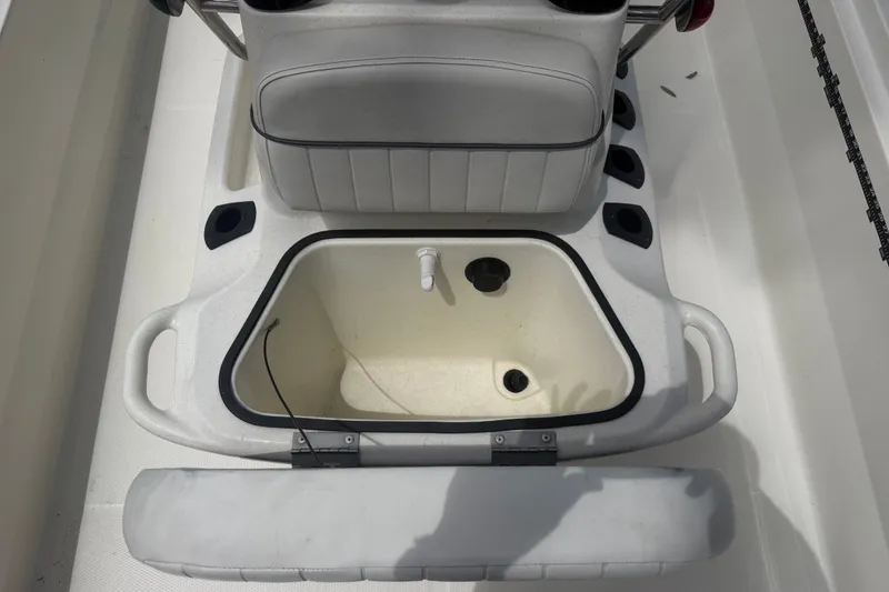 Slide: The Image of 2016 Mako Pro Skiff 16 CC boat interior with open storage compartment. - 26
