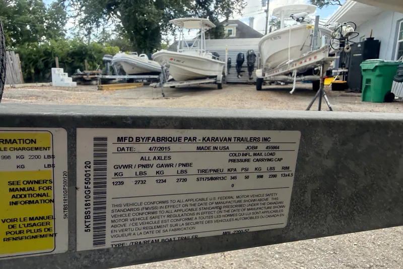 Slide: The Image of Trailer label with specifications, Mako Pro Skiff 16 CC boats in background, 2016 model. - 30