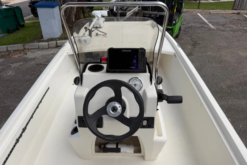 Slide: The Image of 2016 Mako Pro Skiff 16 CC boat console with steering wheel and navigation system. - 15