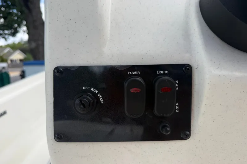 Slide: The Image of Control panel of a 2016 Mako Pro Skiff 16 CC boat with switches and ignition. - 18
