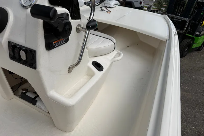 Slide: The Image of 2016 Mako Pro Skiff 16 CC boat interior with steering console and seating. - 20