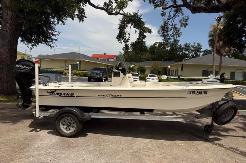 The Image of 2016 Mako Pro Skiff 16 CC boat on trailer, parked outdoors. - 0