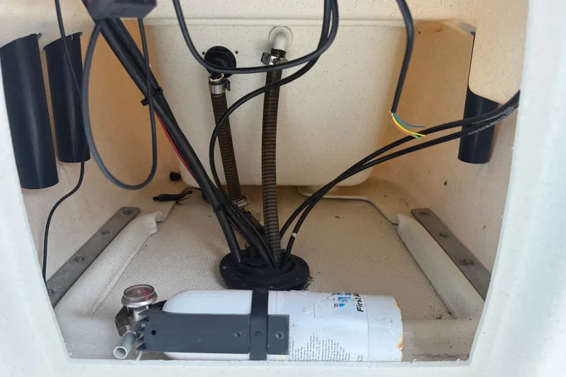 Slide: The Image of Interior view of a 2016 Mako Pro Skiff 16 CC boat showing wiring and components. - 19