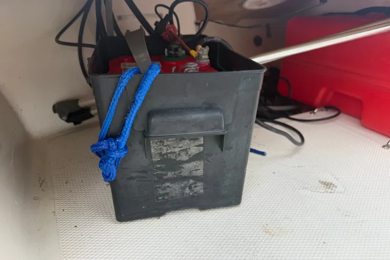 Slide: The Image of Battery box with blue rope inside a 2016 Mako Pro Skiff 16 CC boat. - 14