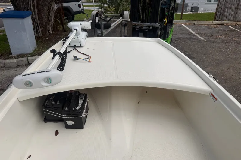Slide: The Image of 2016 Mako Pro Skiff 16 CC boat with trolling motor and battery on deck. - 21
