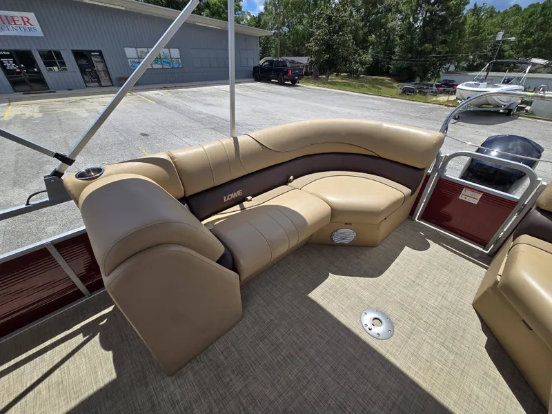 Slide: The Image of The image shows the beige leather seating on a 2020 Lowe SF 232 pontoon boat. - 22