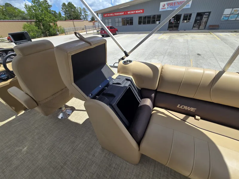 Slide: The Image of The image shows the interior of a 2020 Lowe SF 232 boat with beige seating. - 24