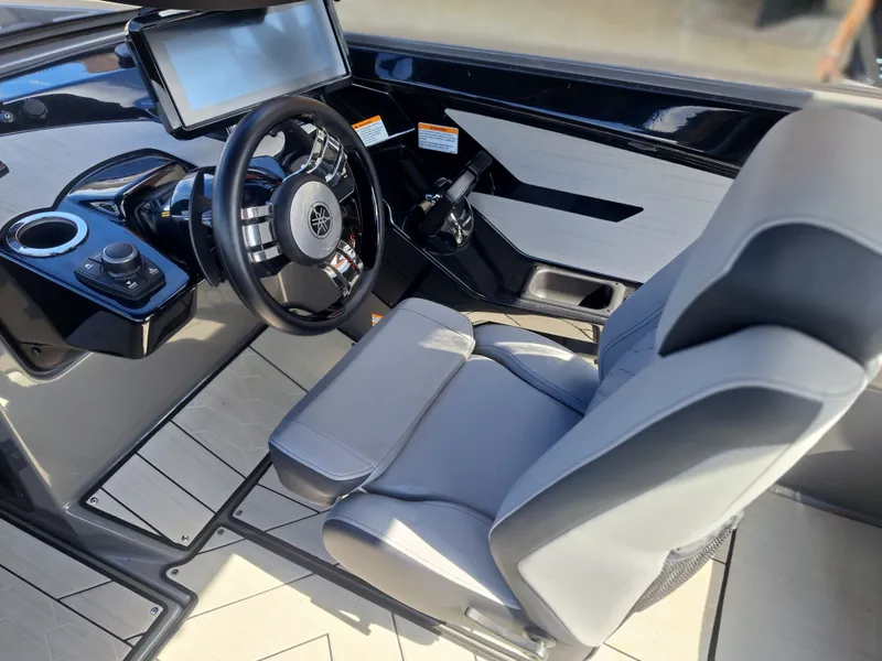 Slide: The Image of The image shows the cockpit of a Yamaha 222XD boat with a modern steering wheel and large display. - 30