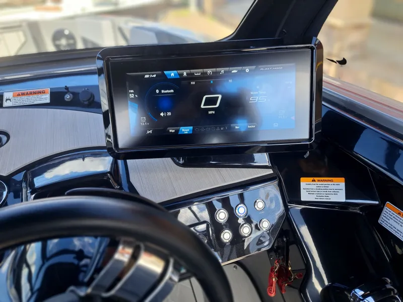 Slide: The Image of The image shows the dashboard of a Yamaha 222XD boat with a modern touchscreen display. - 31