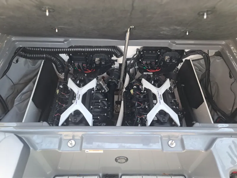 Slide: The Image of The engine compartment of a 2025 Yamaha Boats 222XD features two powerful engines. - 32