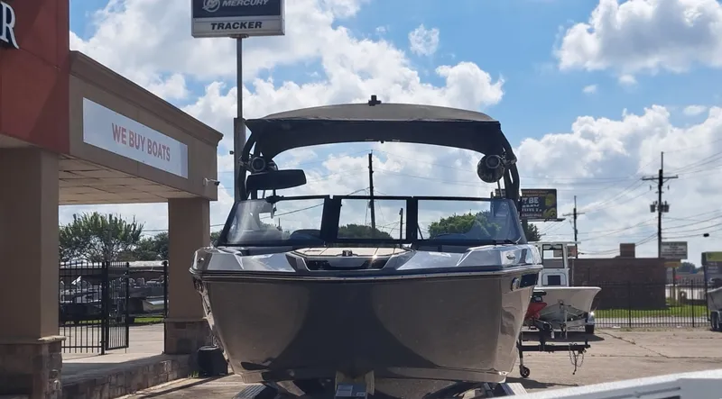 Slide: The Image of A 2025 Yamaha 222XD boat on a trailer in front of a building. - 6