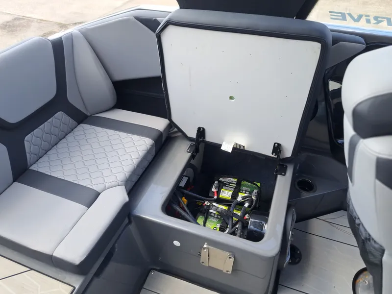 Slide: The Image of The image shows the seating area of a Yamaha 222XD boat with an open storage compartment containing batteries. - 28
