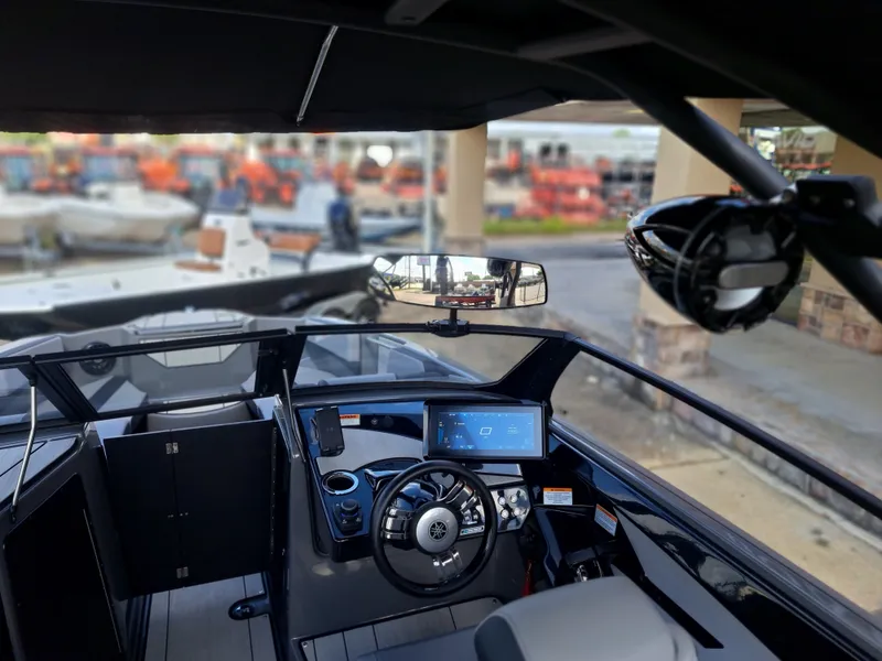 Slide: The Image of The cockpit of the 2025 Yamaha Boats 222XD features a modern dashboard with touchscreen and steering wheel. - 33