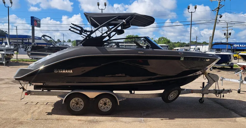 Slide: The Image of A black Yamaha boat, model 222XD, is on a trailer in a parking lot. - 8