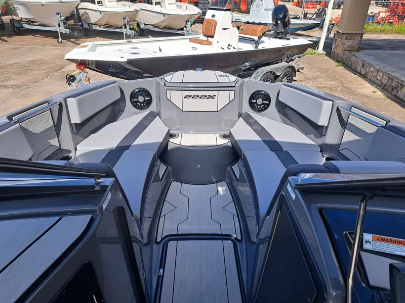Slide: The Image of The image shows the cockpit of a 2025 Yamaha Boats 222XD with gray upholstery and speakers. - 13