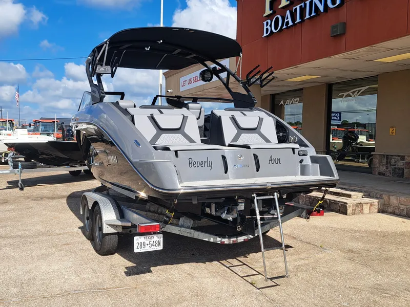 Slide: The Image of A gray 2025 Yamaha 222XD boat on a trailer in front of a building. - 11