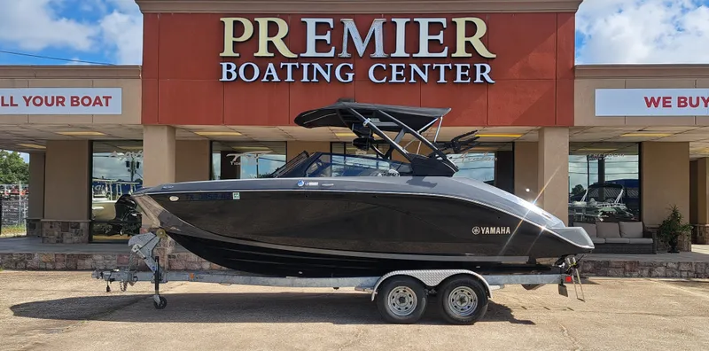 The Image of A 2025 Yamaha 222XD boat on a trailer in front of a boating center. - 1