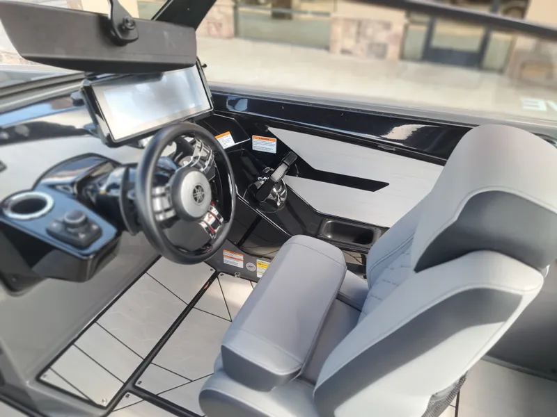 Slide: The Image of The image shows the cockpit of a 2025 Yamaha Boats 222XD with a modern steering wheel and display. - 29