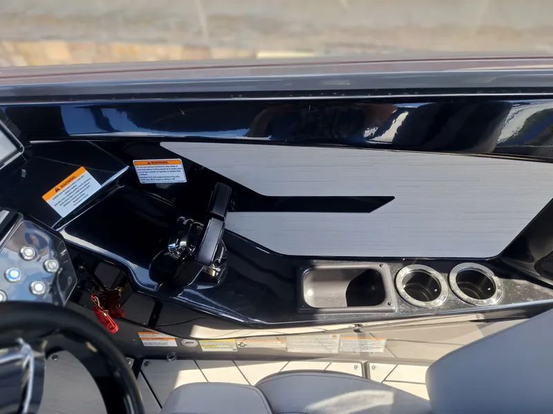 Slide: The Image of The image shows the cockpit of a 2025 Yamaha Boats 222XD with throttle lever and cup holders. - 34