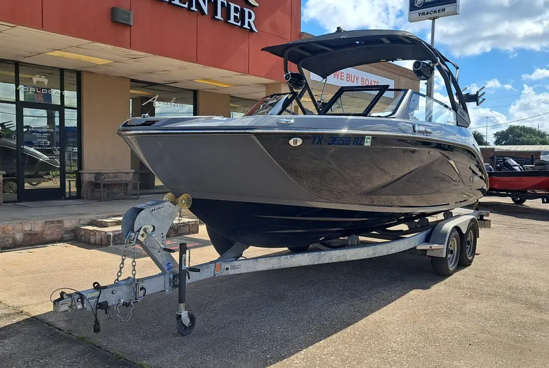 Slide: The Image of A 2025 Yamaha 222XD boat on a trailer in front of a building. - 3