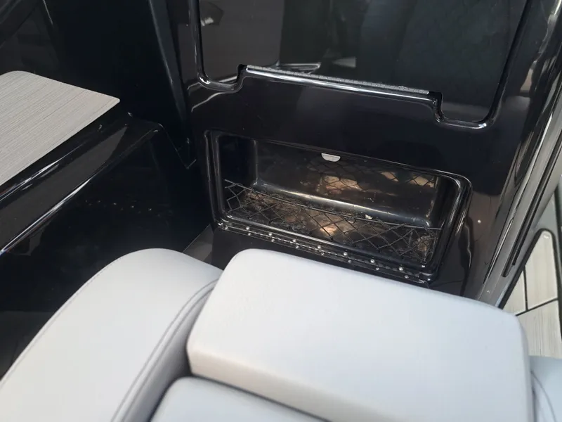 Slide: The Image of Interior of a Yamaha 222XD boat with black storage compartment and gray upholstery. - 23