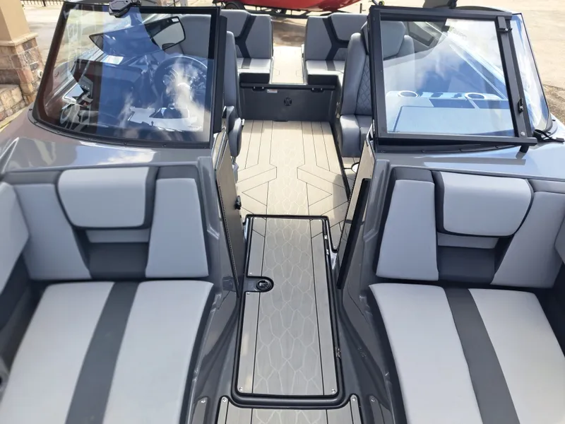 Slide: The Image of The image shows the cockpit of a 2025 Yamaha Boats 222XD with gray and black seating. - 18