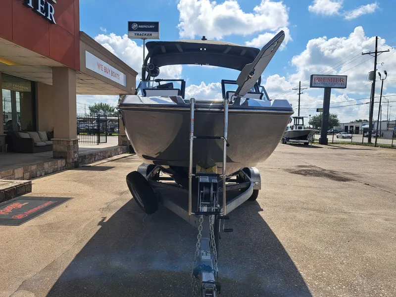 Slide: The Image of A 2025 Yamaha 222XD boat on a trailer in front of a building under a blue sky. - 12