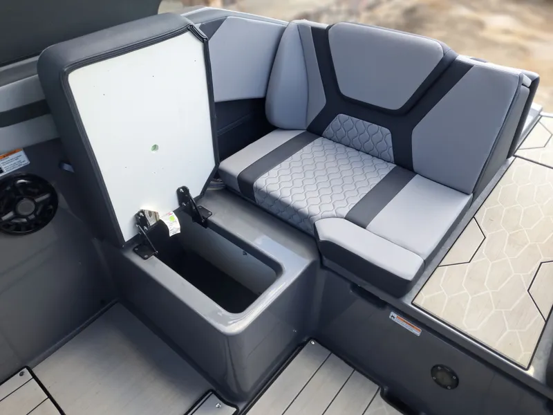 Slide: The Image of The image shows the seating area of a Yamaha 222XD boat with gray upholstery and storage. - 27