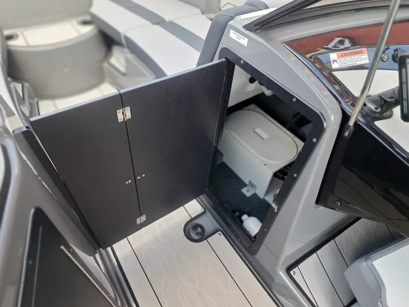 Slide: The Image of The image shows the interior of a 2025 Yamaha Boats 222XD with an open storage compartment. - 19