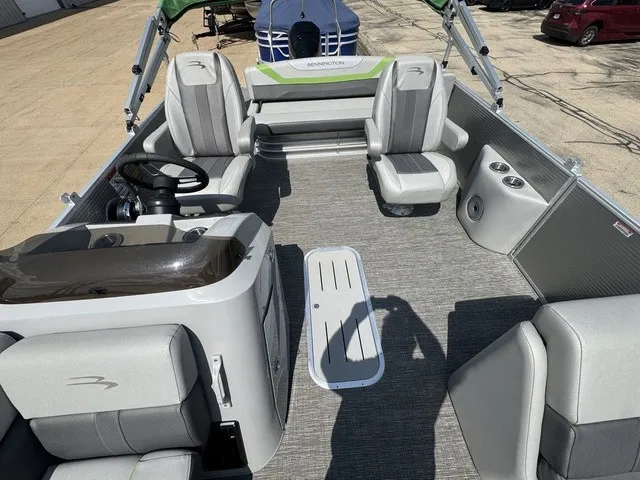 Slide: The Image of The image shows the interior of a 2022 Bennington 22 SSBX pontoon boat with gray seating. - 10