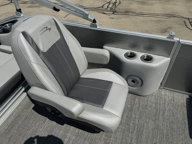 Slide: The Image of A gray upholstered seat with cup holders on a boat. - 13
