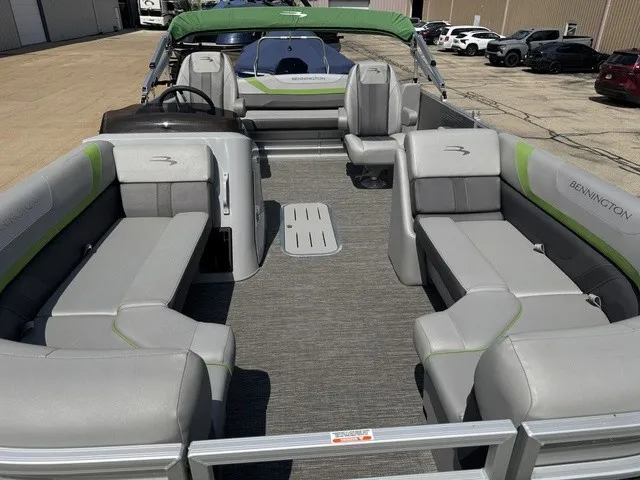 Slide: The Image of The image shows a 2022 Bennington 22 SSBX pontoon boat with gray and green seating. - 6