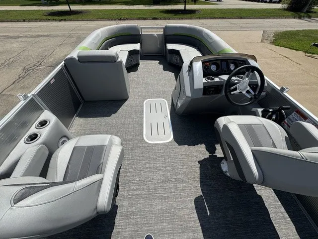 Slide: The Image of The image shows the interior of a 2022 Bennington 22 SSBX pontoon boat with gray seating. - 9