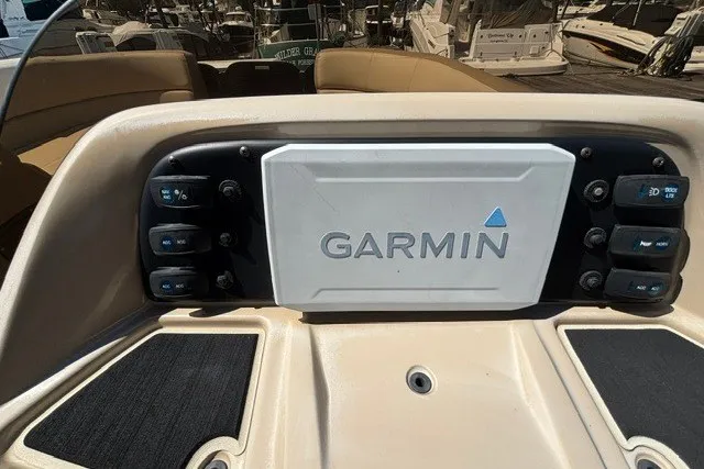 Slide: The Image of Control panel of 2022 Manitou 23 Aurora boat featuring Garmin navigation system. - 21