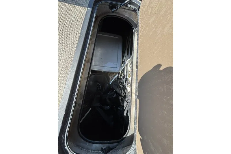 Slide: The Image of Storage compartment of 2022 Manitou 23 Aurora boat, containing various items and equipment. - 33