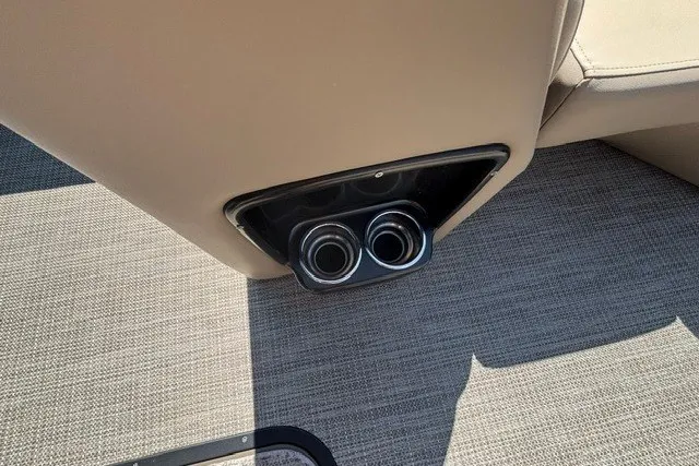 Slide: The Image of Cup holders on 2022 Manitou 23 Aurora boat with beige interior and carpeted flooring. - 32
