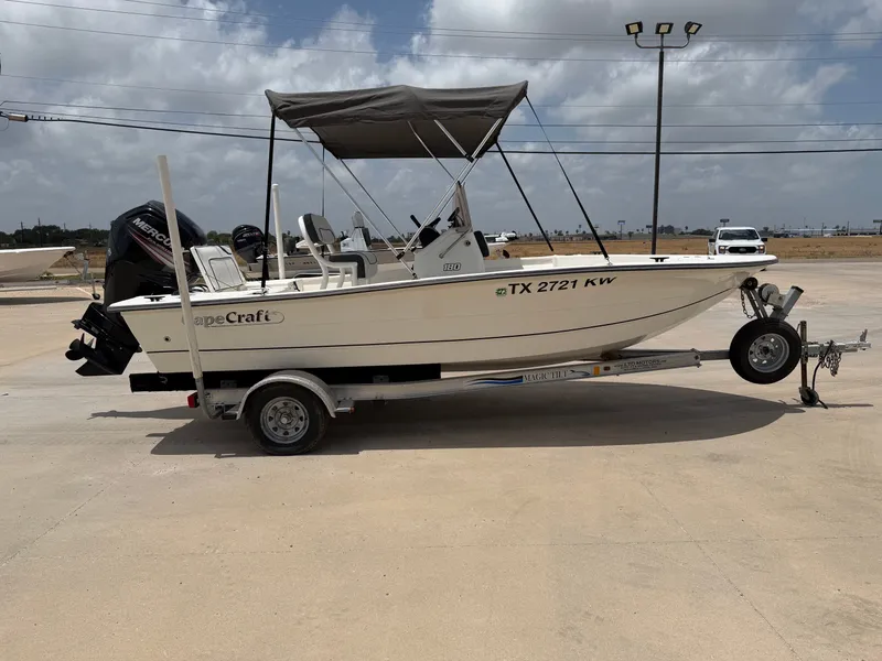Slide: The Image of A 2016 Cape Craft 180cc boat on a trailer, featuring a Bimini top and outboard motor. - 7