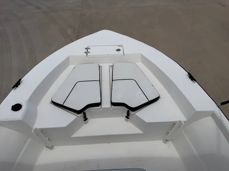 Slide: The Image of The image shows the bow deck of a 2016 Cape Craft 180cc boat with storage compartments. - 12