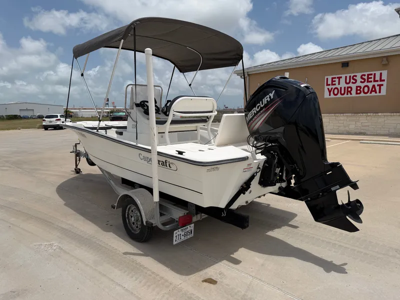 Slide: The Image of A white 2016 Cape Craft 180cc boat with a Mercury outboard motor, parked on a trailer. - 10
