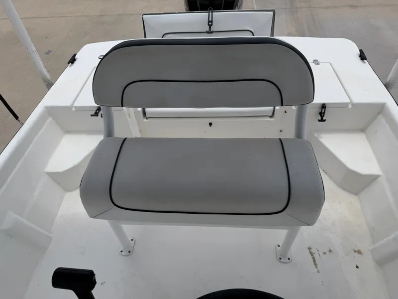 Slide: The Image of The image shows a gray bench seat on a white boat, likely a 2016 Cape Craft 180cc. - 22