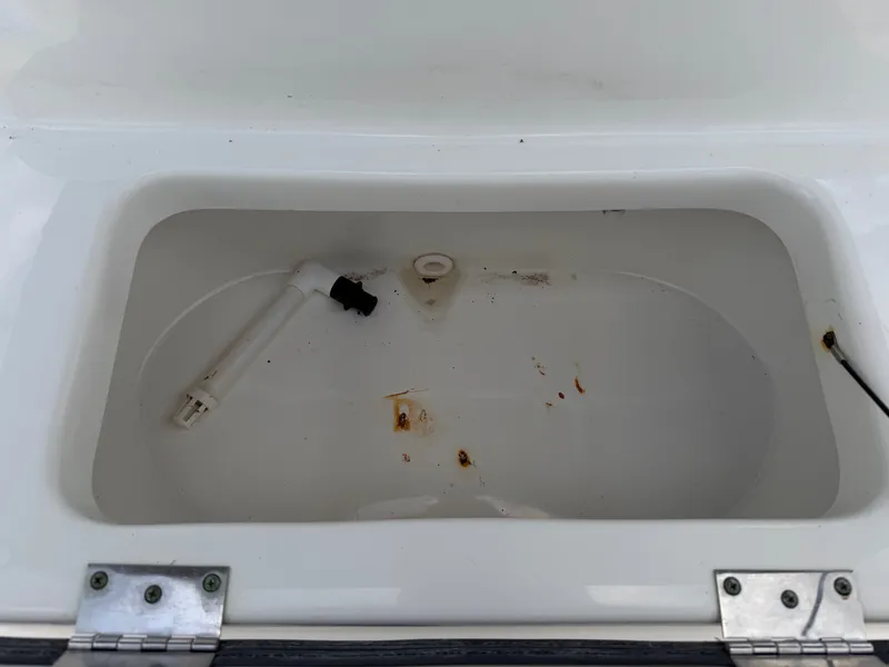 Slide: The Image of An open compartment on a boat with a pipe and some dirt inside. - 19